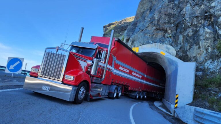 Kenworth truck with RHINO guards and low-profile tyres passing through tunnel.